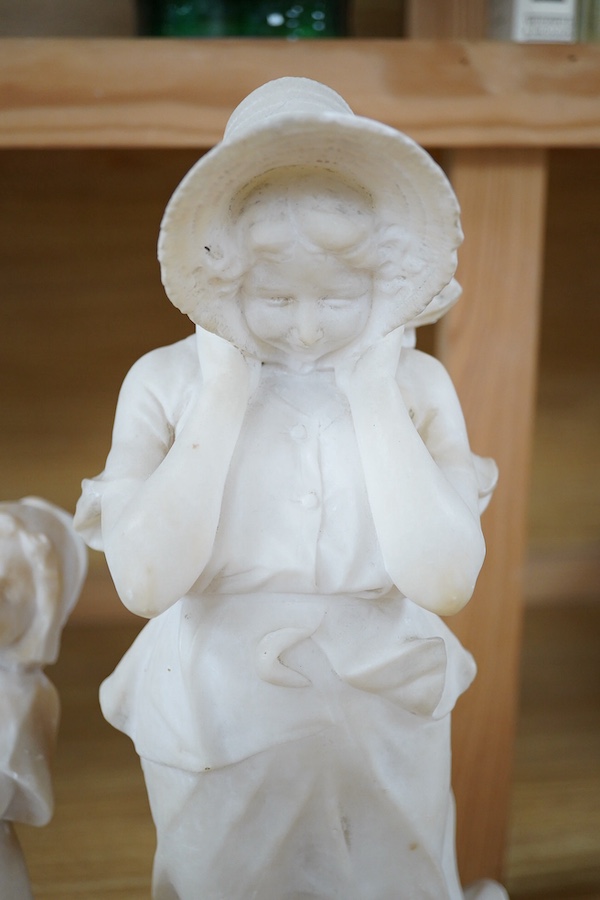 Two 20th century carved alabaster figures of young girls, one of a Dutch girl, the other larger, of a girl in a straw hat, 46cm high. Condition - Dutch girl good, girl with straw hat base broken to one corner